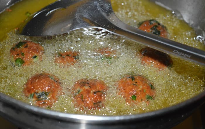 Fry the balls until they are golden brown and crunchy. Turn them occasionally to ensure uniform frying.
