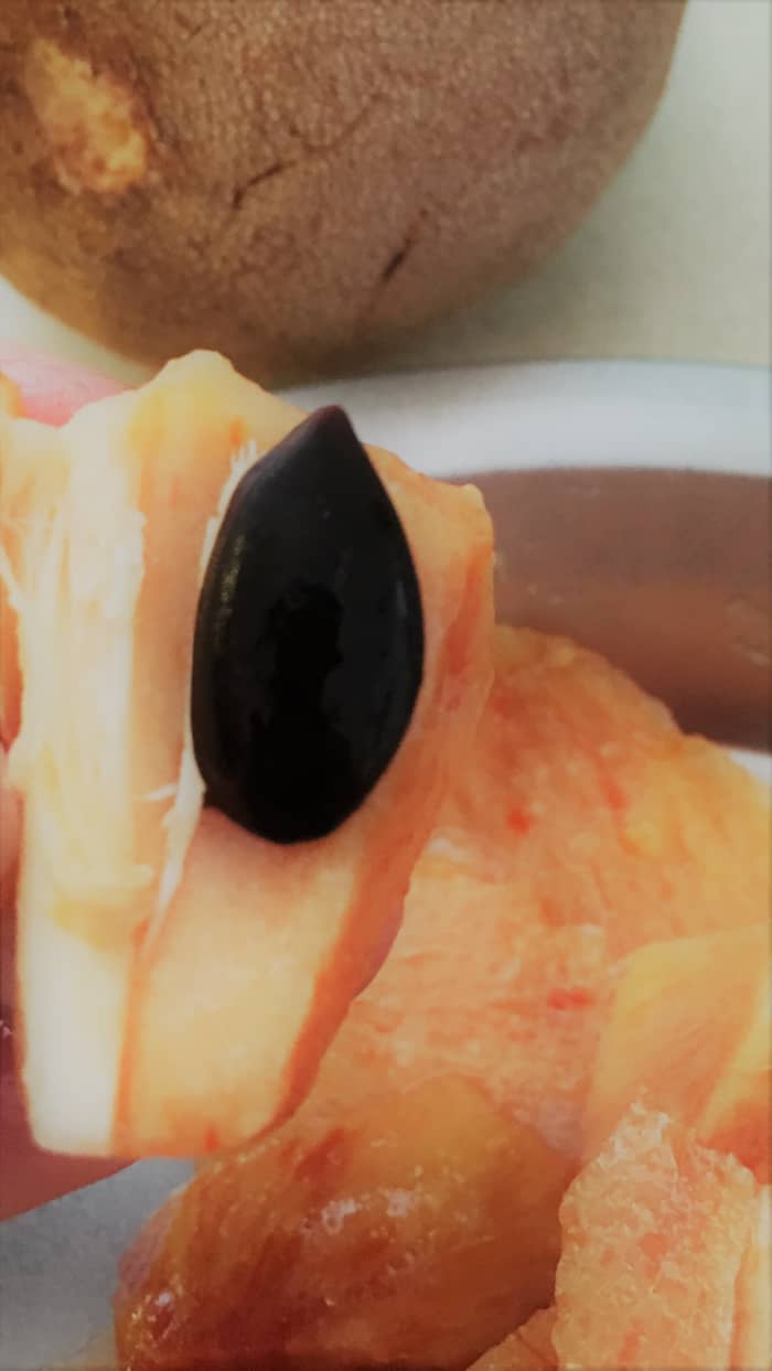 Sapodilla flesh when ripened is deep yellow and soft. The seeds are not edible and can be tossed out.
