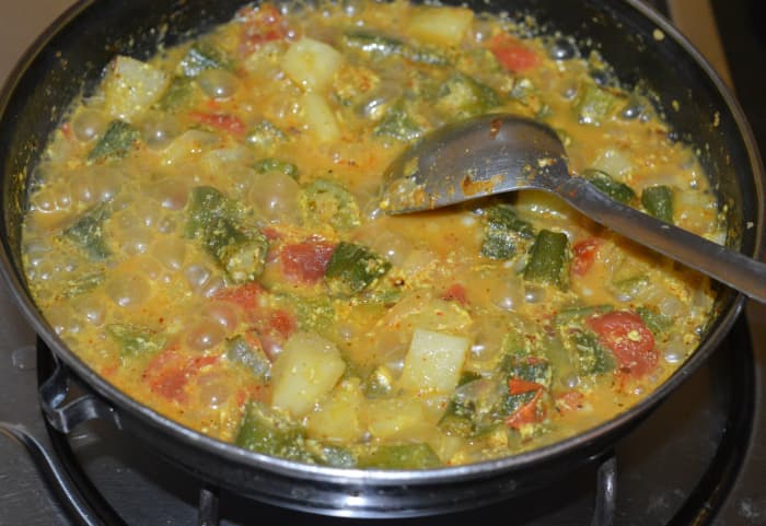 Turn off the flame. Your favorite okra potato curry is ready to serve! Garnish with finely chopped coriander leaves. Serve with roti, chapati, or rice. Enjoy eating!