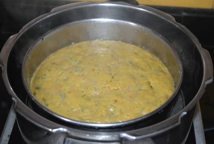 Step four: Cook it in a steamer or pressure cooker. If using a pressure cooker, don't use the weight. Steam-cook over medium-high flame for 15-16 minutes. Turn off heat. After cooking, the cake appears like this.