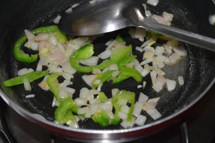 3. Saute the chopped onions in oil until the onion becomes pinkish. Throw in the capsicum strips. Saute for 1 minute.