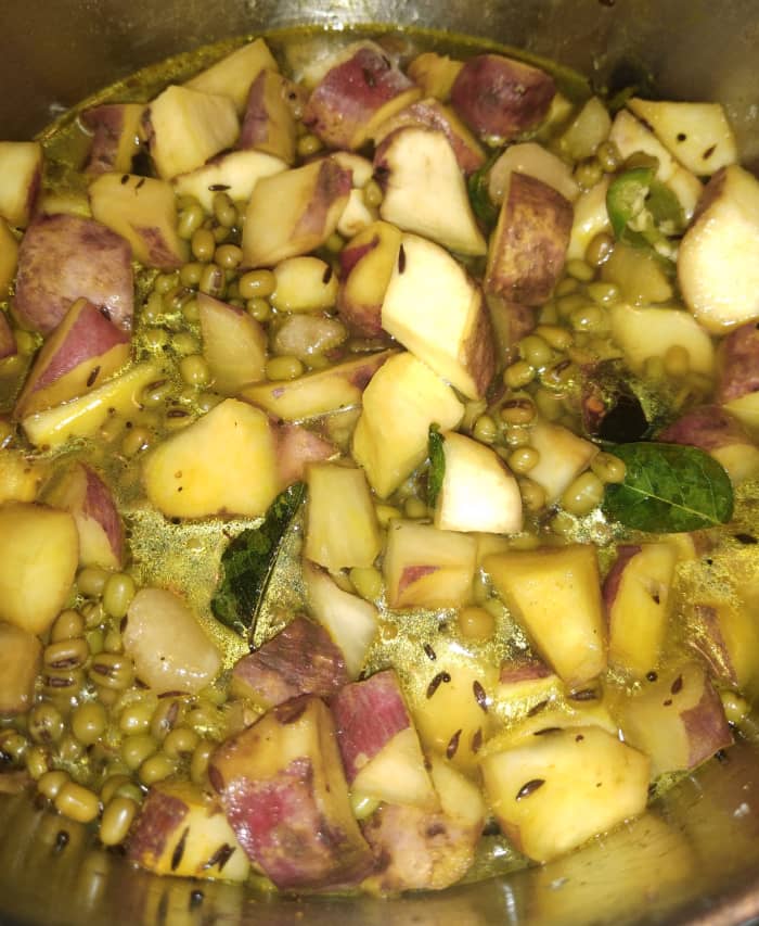 Mix everything properly. Add about 1 cup of water or just enough to immerse the sweet potato and green gram. Cover and cook. Stir occasionally for even cooking.