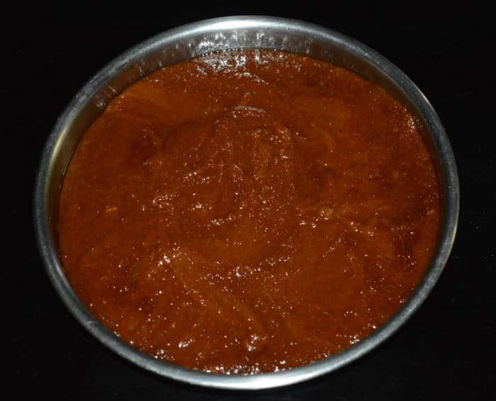 Step five: At this point, turn off the heat and pour the mixture onto a greased plate. Spread it with a spatula.