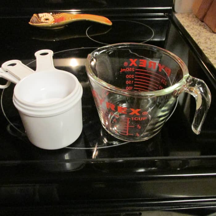 Dry measure with the cups on the left. Liquid measure with the glass cups on the right.