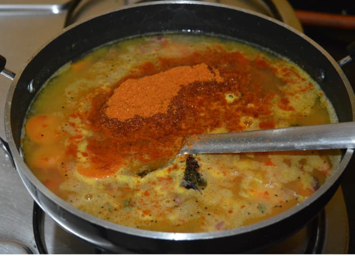 Add turmeric powder, tamarind paste, jaggery powder, remaining salt, and sambar powder. Add 3-4 cups of water.
