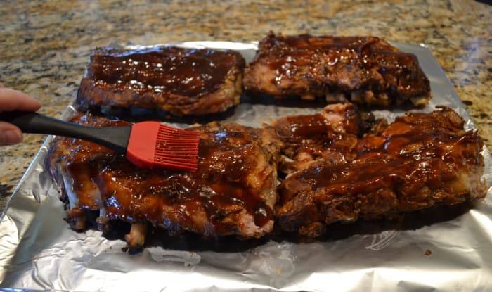 Carefully remove ribs from the slow cooker and place them on a foil-covered cookie sheet. Brush with a bit more barbecue sauce and place under the broiler for just a few minutes.