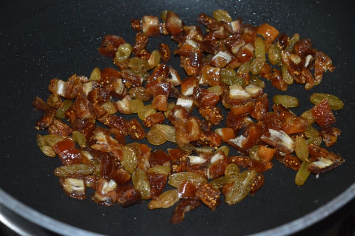 In the same pan, add chopped dates, raisins, and dried figs. Saute with a very small amount of ghee just for a few seconds. Transfer the mixture to a plate.