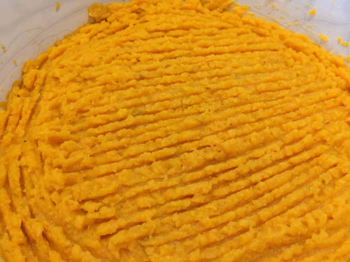 Smooth the mash over the dish, right up to the edges, and create furrows with a fork to give a crispy finish.