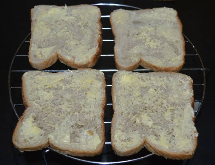 Step one: Make the bread slices firm by grilling in the oven for 2-3 minutes. Apply butter on the top side. Arrange them on a grill stand.