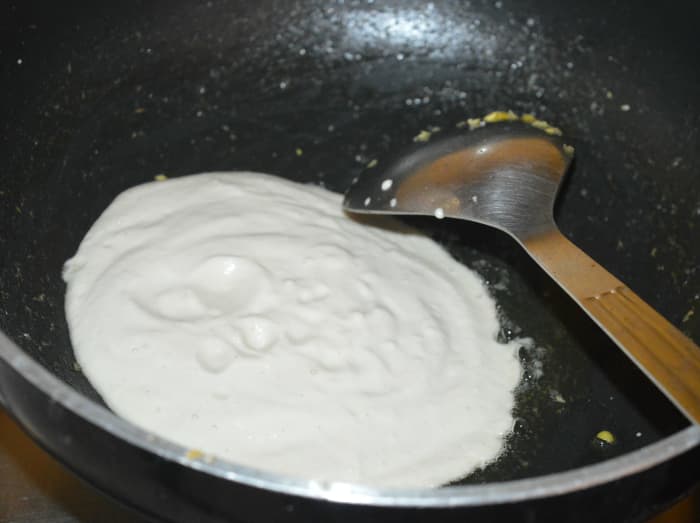 Step four: Add the remaining oil to the pan. Add the paste. Saute it over very low heat until it becomes thick and the oil comes out around the edges.