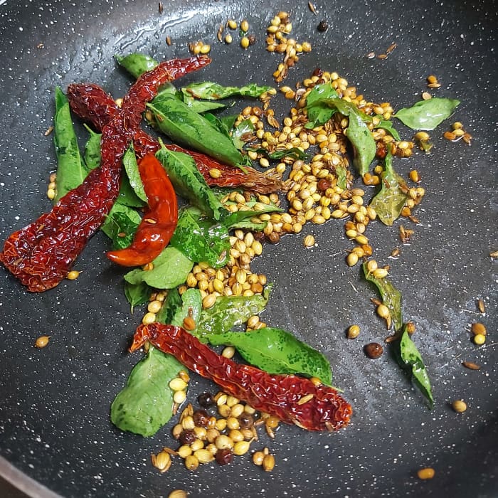 Add 3-4 dry red chilies and 1-2 springs of fresh curry leaves. Saute till the red chilies turn crisp. (I used guntur red chilies to give spiciness and byadagi red chilies to give color). Switch off the heat.