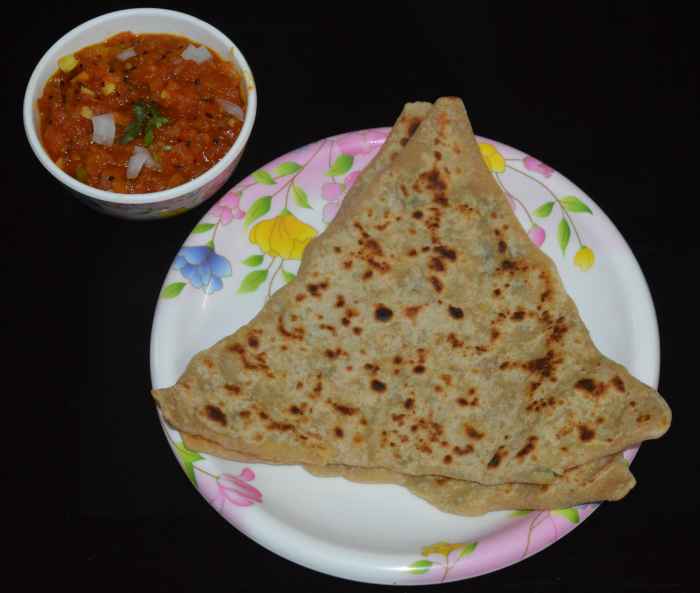 Serve hot paneer parathas with tomato salsa, tomato sauce, or any tangy sauce. Enjoy the taste!