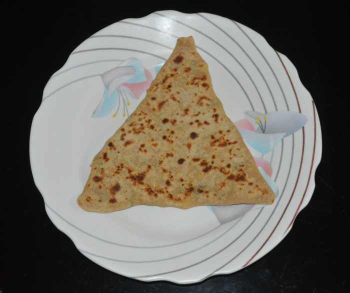 Transfer the cooked paratha from the pan and place on a serving plate. Similarly, make all the parathas. You can make 8 parathas in this recipe.