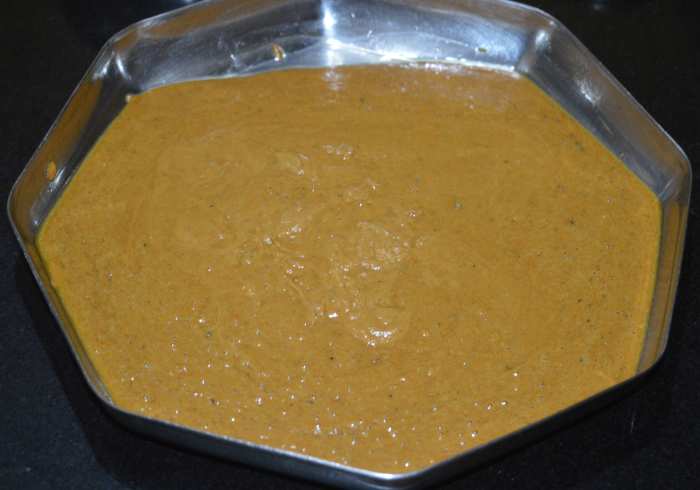 Step four: Pour the burfi mixture on the greased plate. Flatten it with the help of a spatula.