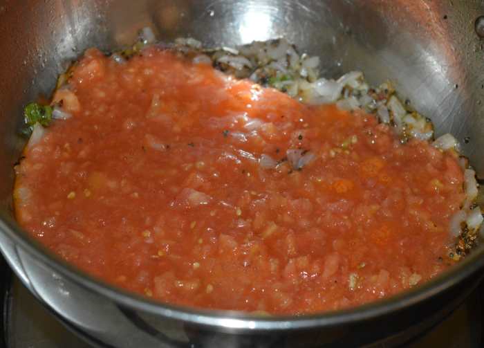 Step three: Add chopped tomatoes and some salt. Cook the mixture for 4-5 minutes over medium heat. 