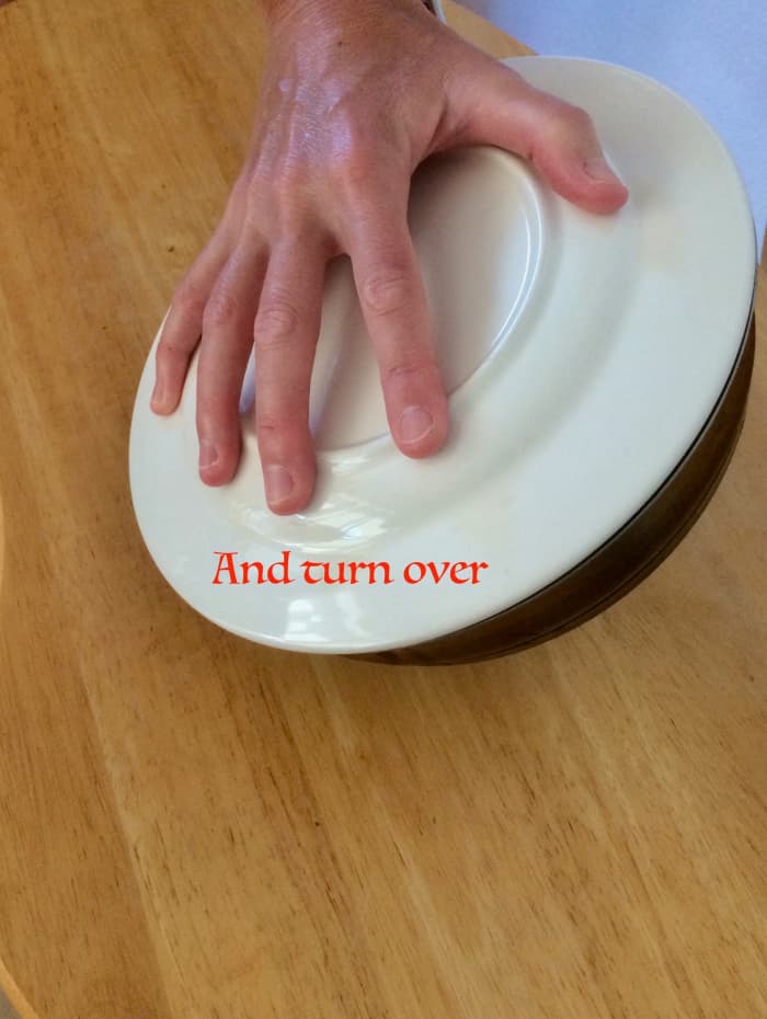 Turn the mixture onto the plate. The frittata will be upside-down. Slide the frittata back into the pan and continue to cook. The cooked side will now face up.
