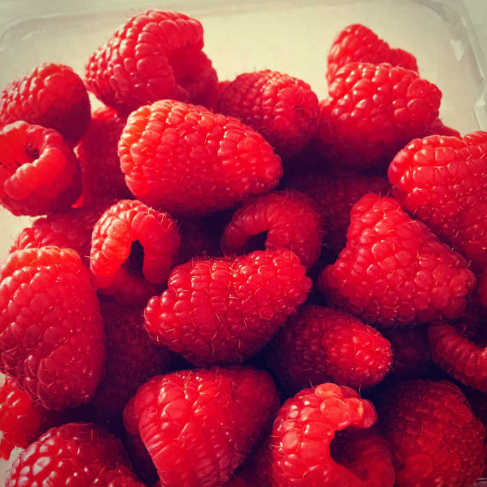 Fresh raspberries waiting to be used as cupcake garnishes.