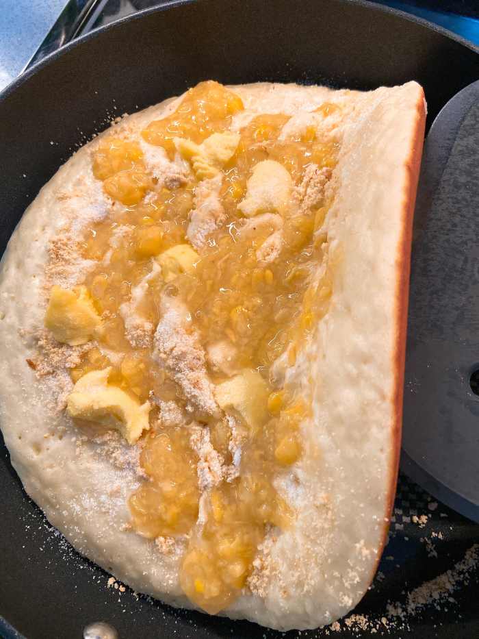 Turn or fold the pancake with a wide spatula. 