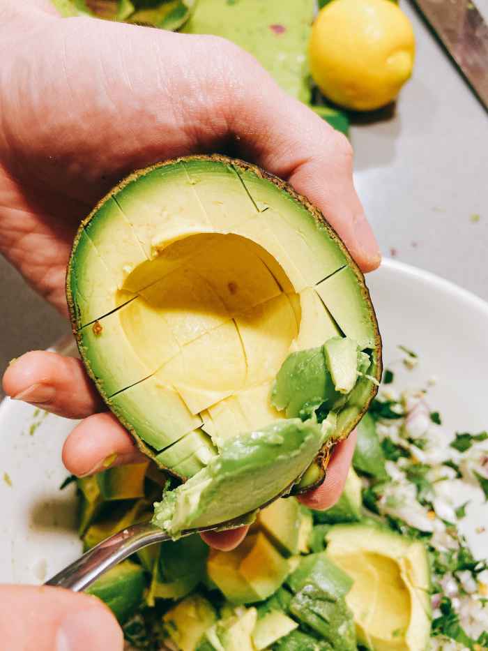 Scoop out the avocado with a large spoon and combine into the bowl.