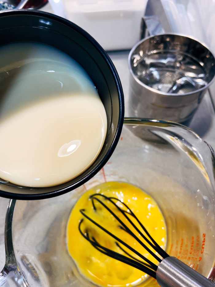 Combine the condensed milk into the egg mixture.