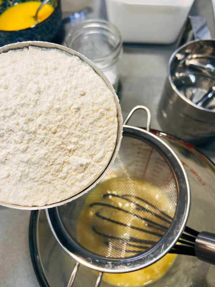 Sieve the flour into the egg mixture. Whisk the mixture until well-combined.