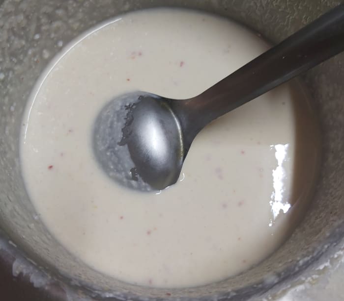 Add 1/2 teaspoon of baking soda and mix well. Add more water if required to make the batter flowing consistency (batter should not be very thick nor too watery).