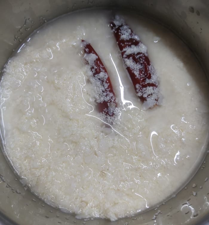 Add 1-2 red chilies (I used guntur red chilies here) and 1/2 cup of water or just enough to immerse the mixture. Soak for 5 minutes.