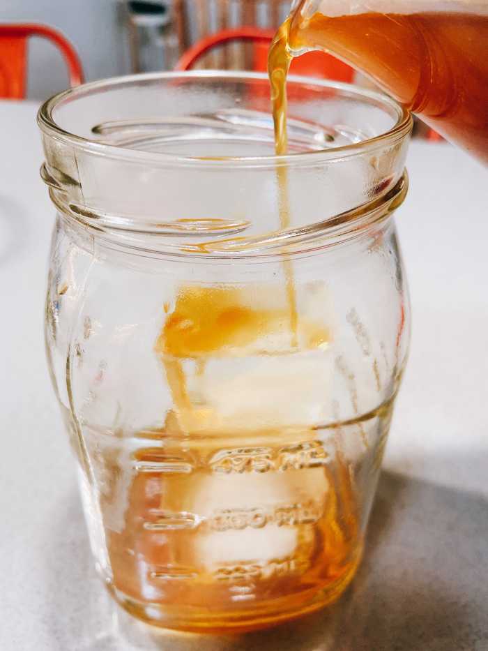 In a glass, add a few ice cubes and pour the cold brew coffee.
