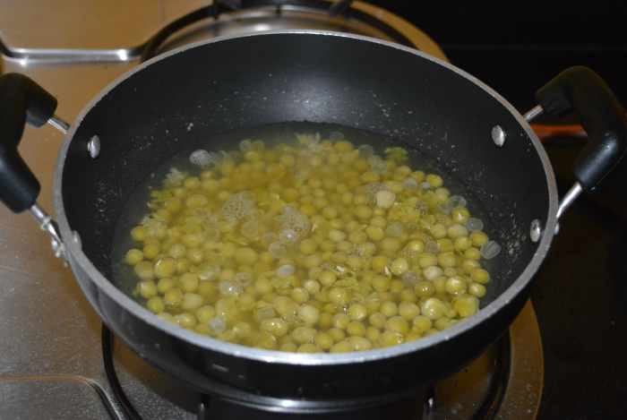 Step two: Cook soaked white peas with some water and salt. Add it to a deep-bottomed pan.