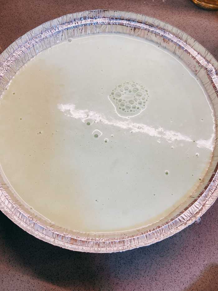 Pour the batter into a greased round or square pan.