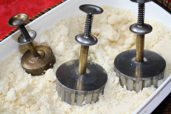 Push the base or bottom part of the polvoron (or mooncake) mold down into the mixture, making sure the mixture inside the mold is as compact as possible.