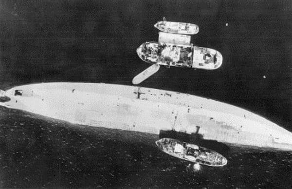 Tromso fiord, Norway. A reconnaissance photograph showing the capsized hull of the German battleship Tirpitz after attack on 1944-11-12 by Lancaster aircraft of no. 9 And no. 617 Squadron RAF, with 12,000 pound bombs.