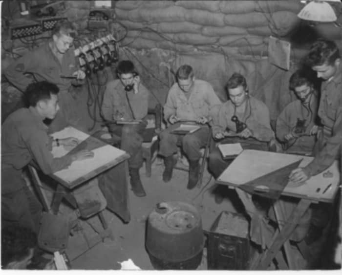 Artillery FDC in Italy. In the back left, you can see the wood rack holding the ubiquitous phones. Also note the use of a sheaf on the plotting tables. This aided in delineating planes of fire for multiple artillery pieces.