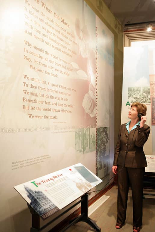 Mrs. Laura Bush listens to a reading of a Paul Laurence Dunbar poem during a tour of the Wright-Dunbar Village, a Preserve America neighborhood honoring the Wright brothers and Dunbar, in Dayton, Ohio. Photo taken Wednesday, August 16, 2006.