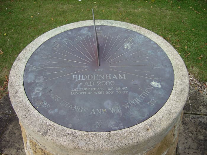 This is a horizontal sundial sporting all the features a sundial has to offer. If you look closely at the bottom of the face, you will see the motto, "Times change and we with them".