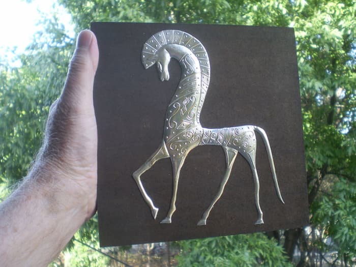 An example of repoussé, the art of beating and inscribing designs in metals such as tin, by the Mexican artist, Manolo Vega.