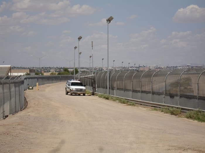 The border fence stretches along much of the otherwise most accessible sections of the border. Here, a patrol car maintains surveillance of the border.