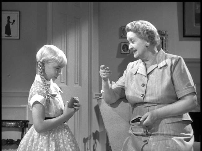 Mrs. Breedlove (Evelyn Varden) offers a gift to Rhoda. This helps display Rhoda's preoccupation with material items.