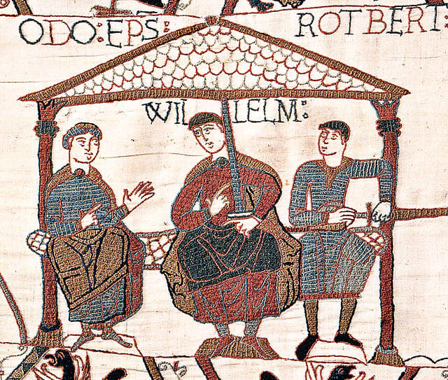 Image from the Bayeux Tapestry showing William the Conqueror (also sometimes referred to as William the Bastard) with his half-brothers. William is in the center, Odo is on the left with nothing in his hands, Robert is on the right holding a sword,
