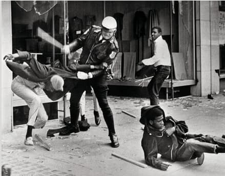A police officer uses his nightstick on a youth reportedly involved in the looting that followed the breakup of a march led by Dr. King on March 28, in Memphis. Later in the day, Larry Payne, the 16-year-old in the background, was killed by police.