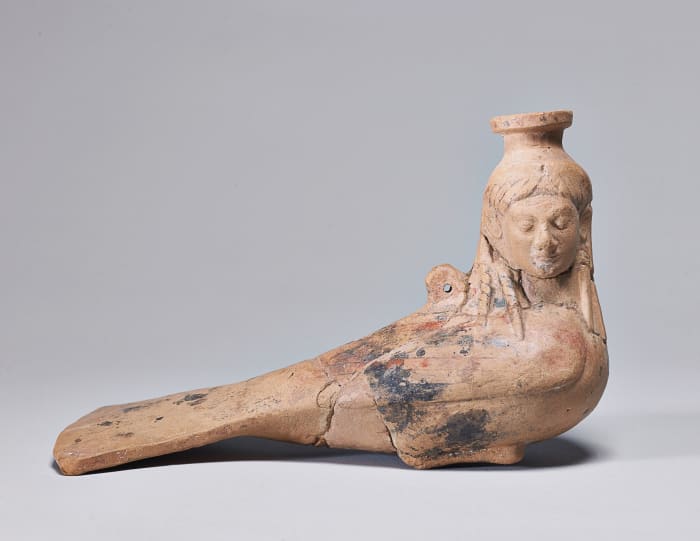 A perfume vase in the form of a Siren, circa 540 BC