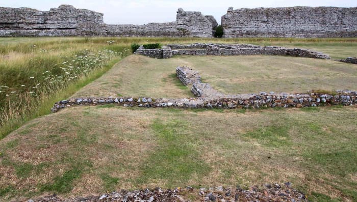 The foundations of town buildings dating from 100 AD - 250 AD. These are believed to be houses and shops. On the left is one of the 3rd century trenches constructed as Rutupiae returned to its fortress status