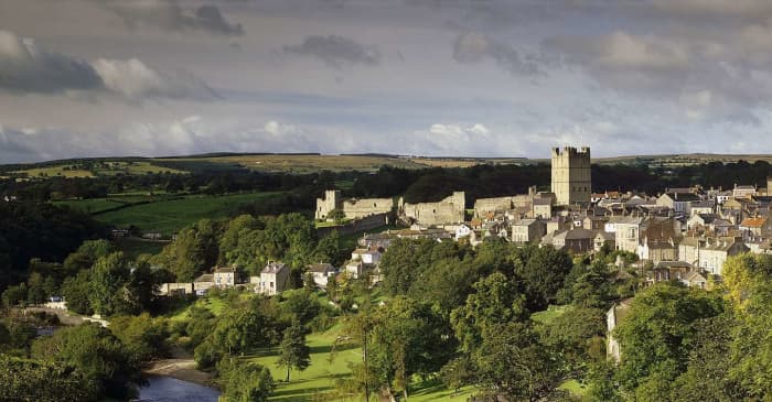 Richmond Castle and town in its setting at the crown of the hill, overlooking the Swale and backed by the Dales scenery