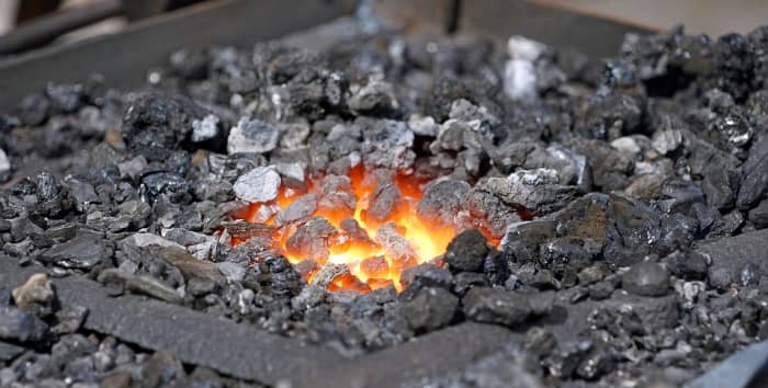 The burnt out hearth still has fiery sparks submerged in ash. Shakespeare uses this image to communicate the lingering passion within his tired heart