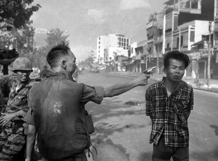 Gen. Nguyen Ngoc Loan, South Vietnamese chief of the national police, fires his pistol into the head of suspected Viet Cong official Nguyen Van Lem on a Saigon street early in the Tet Offensive, February 1, 1968.