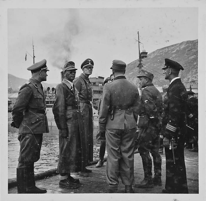 The pride of the Third Reich endures a bit of inclement weather in the Hammerfest harbour. Second from left is Josef Terboven head of the German occupation. When Germany surrendered he blew himself up.