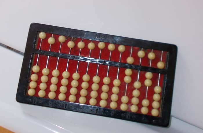 Remainders will appear after the quotient is found in the columns on the right hand side of the abacus. This abacus shows the quotient 7 with a remainder of 25.