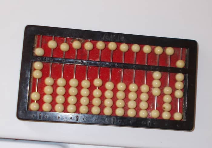 Division problems are placed on the abacus in a different way. The abacus in this photo reads: 308 divided by 7.