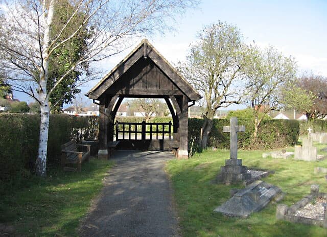 A lych gate is a gateway with a roof found at the entrance to a churchyard. This lych gate is located in Great Shelford.