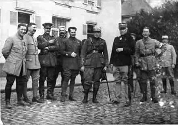 WWI: Churchill, center, wearing his French steel helmet, at French army headquarters at Camblain L'Abbe, 1915.